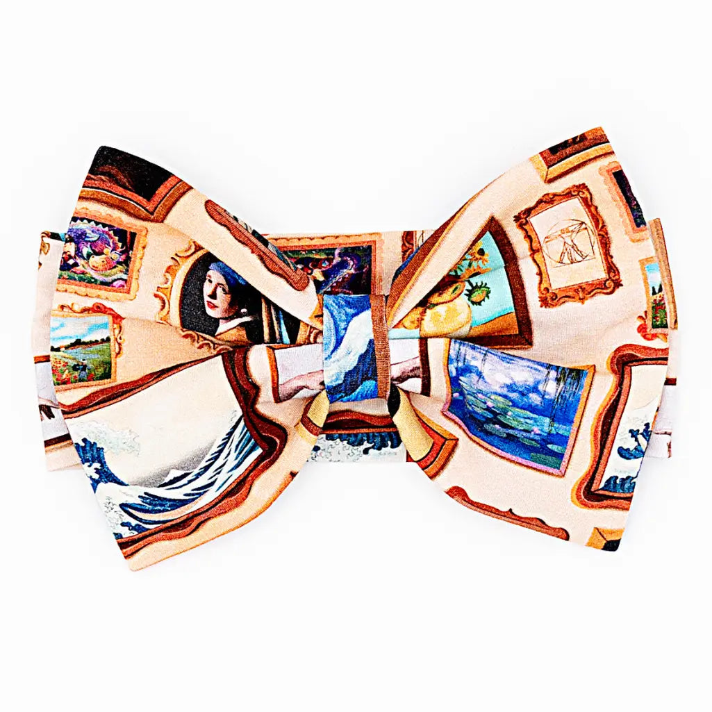 A bow headband with a framed classic paintings print shown on a white background.